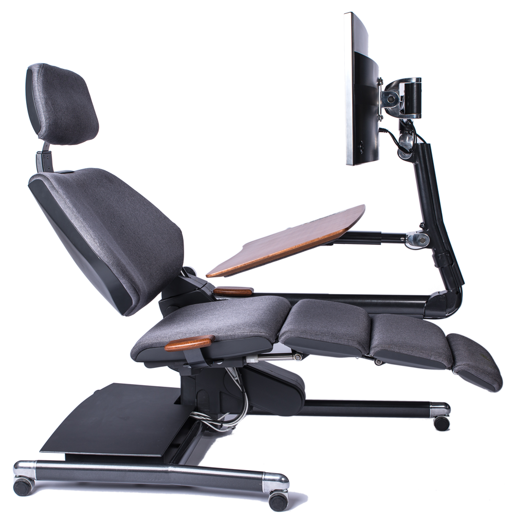 Side view of slightly reclined focus position Altwork chair grey fabric simulated wood work surface and large monitor