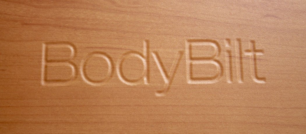 Bodybilt logo embossed in wood finish surface